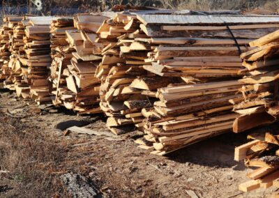 Spruce wood slabs and by-products stacked outdoors